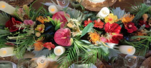 Vibrant floral table runner with candles, creating a festive atmosphere.