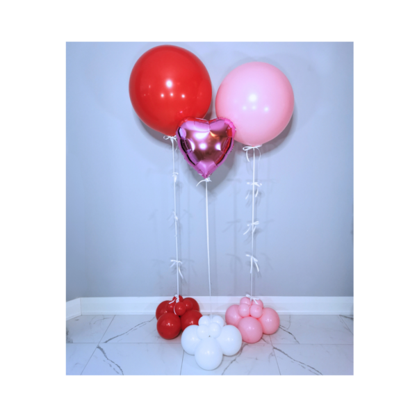 Red, pink, and purple helium balloon cluster.