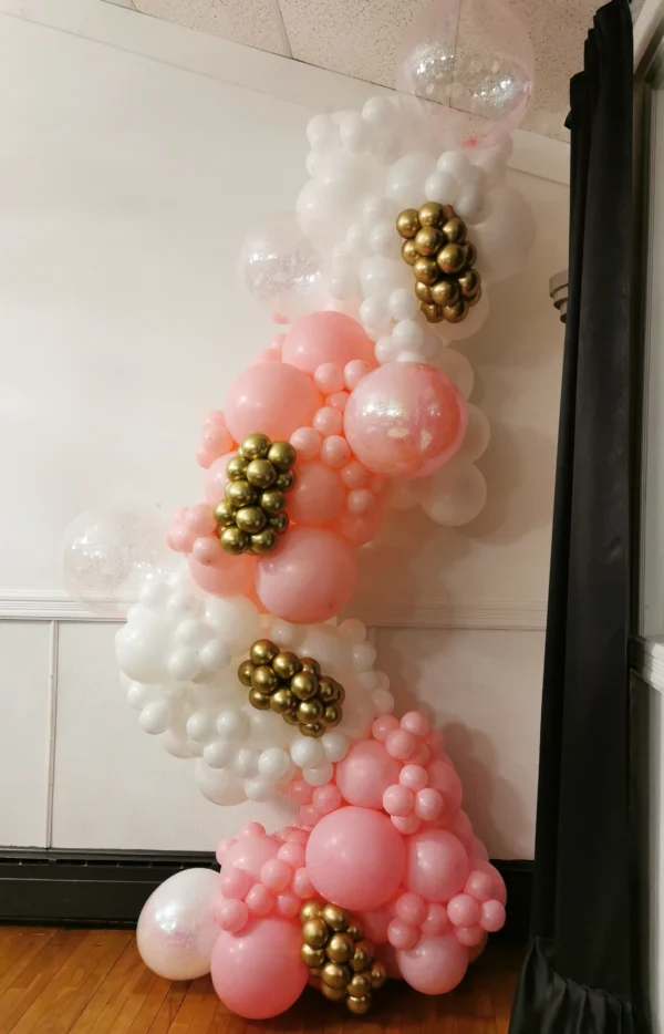 Pink and white balloon garland with gold accents.