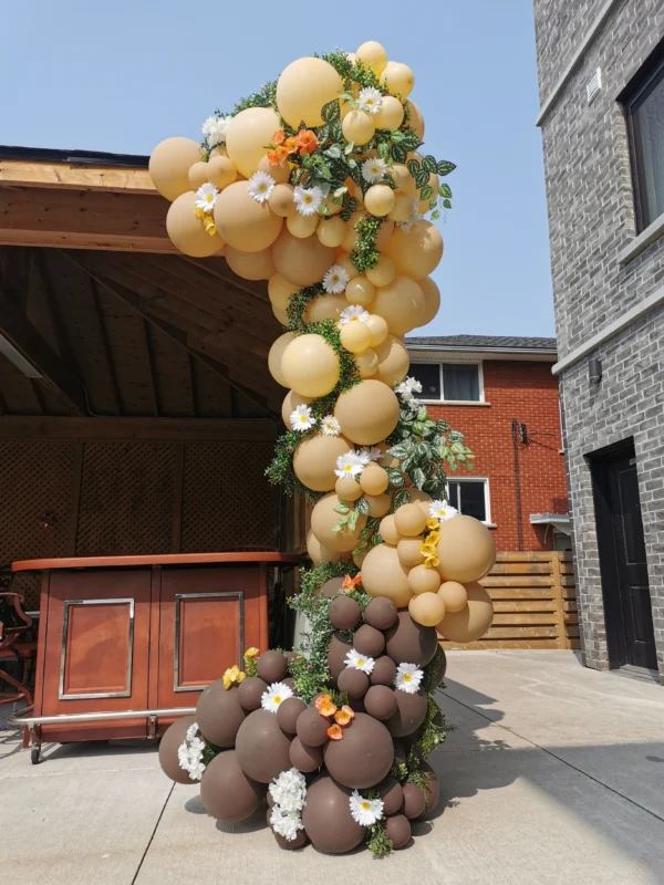 Brown toned balloon garland attached to a gazebo column.