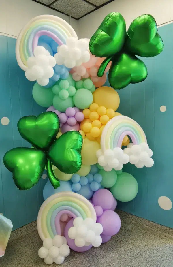 Colorful balloon decorations featuring rainbows, clouds, and green shamrocks, ideal for festive occasions or parties.