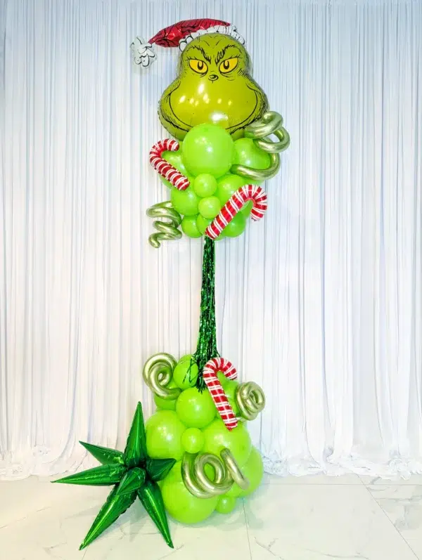 A festive Grinch balloon decoration with green balloons and candy canes, perfect for holiday celebrations.