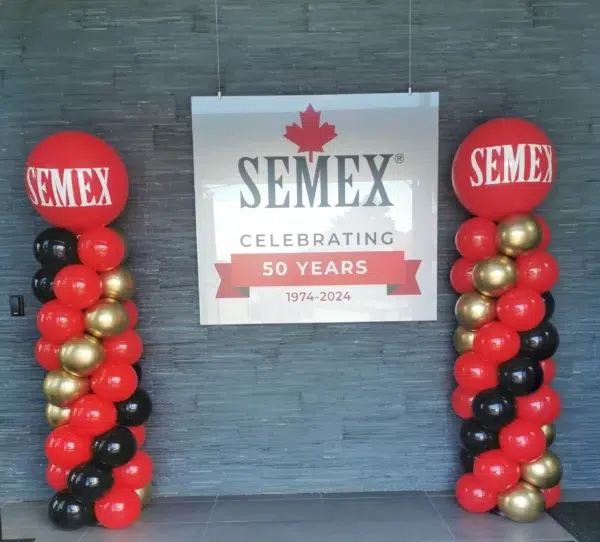 A SEMEX display banner with the tagline "Genetics for Life" next to a decorative balloon stand, set in a ballroom venue.