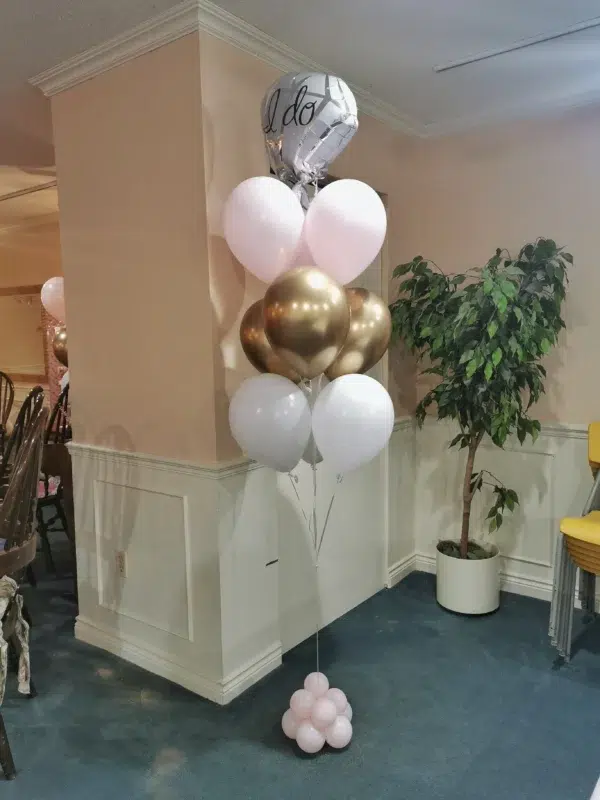 Decorative balloon arrangement featuring a silver "I do" balloon, pink, white, and gold balloons, perfect for wedding celebrations.