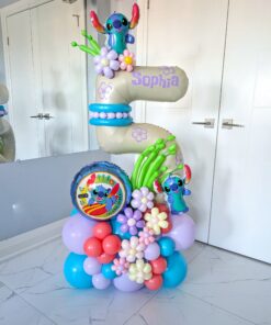 A vibrant balloon number stack featuring Stitch characters, tropical-themed floral balloon décor, customizable numbers, and personalized name decals.