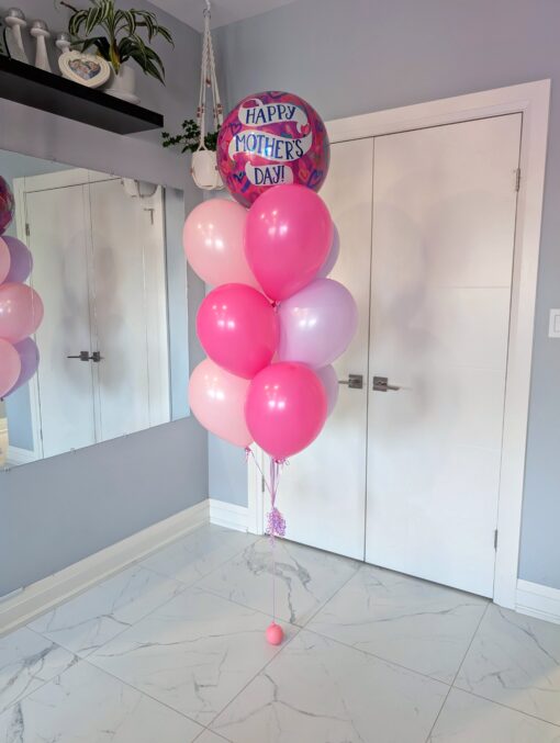 Mother’s Day balloon bouquet with pink and light purple latex balloons and a foil "Happy Mother’s Day" balloon on top, tied to a pink water weight.