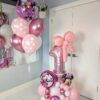 Pink Minnie Mouse-themed balloon combo with number stack, custom name decal, balloon bow, and helium balloon bouquet with polka dot details.