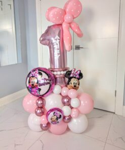 Minnie Mouse-themed balloon stack with a pink foil number balloon, polka dot balloon bow topper, and Minnie Mouse foil accents in pink, white, and metallic colours.
