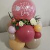 Mother's Day balloon arrangement with pastel-coloured balloons, artificial floral accents, and a personalized decal reading "Happy Mother's Day".