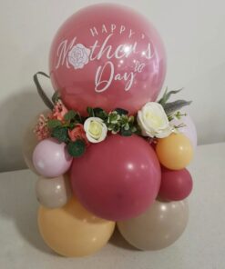 Mother's Day balloon arrangement with pastel-coloured balloons, artificial floral accents, and a personalized decal reading "Happy Mother's Day".