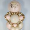 Balloon display with cream, blush, and gold balloons, metallic gold mini garland, and a personalized large balloon topper.