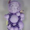 Lilac and lavender balloon display with large speckled balloon, metallic mini garland, and butterfly decorations.