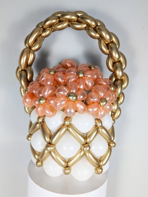 Balloon basket with white and gold balloons, topped with removable peach balloon flowers with gold centres, featuring a gold balloon handle.