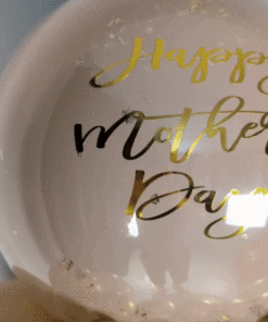 Balloon display with cream, blush, and gold balloons, metallic gold mini garland, and a personalized large balloon topper.