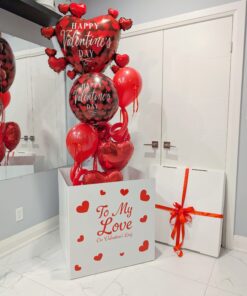 Large white Valentine’s Day box with red hearts releasing helium heart balloons that float upward when opened.