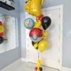 Pokémon Pikachu themed helium balloon bouquet with Poké Ball balloon and red yellow black balloons.