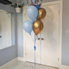 Sonic the Hedgehog themed helium balloon bouquet with Sonic orb balloon and blue and gold balloons.