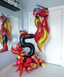 Fire truck themed balloon setup with red and black number stack, flame balloons, helium bouquet, and personalized name decal