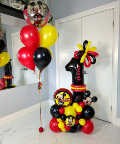 Mickey-themed balloon setup with red, yellow, and black number stack, helium bouquet, and personalized name decal