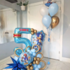 Sonic themed balloon setup with blue and gold number stack, helium bouquet, character balloons, and personalized name decal