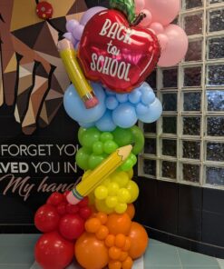 Colourful back-to-school organic balloon column with red apple and oversized pencil balloons.