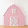 Pink farmhouse barn backdrop with white doors, window, roof trim, and rooster weather vane.