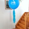 Blue personalized First Day of School jumbo helium balloon with a white grade decal, tassel tail and balloon base.