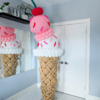 Giant balloon ice cream cone sculpture with two scoops, colourful sprinkles and a cherry topper.