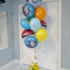 Pokémon helium balloon bouquet with Poké Balls, Pikachu, Snorlax, Charmander, Squirtle, and a colourful balloon base.