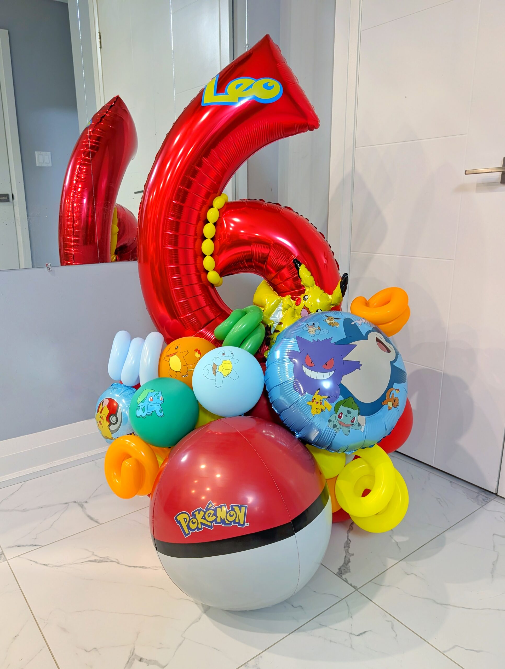 Pokémon birthday number stack with colourful balloons, character accents and a personalized name decal.