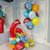 Pokémon-themed personalized number stack with a coordinating colourful helium balloon bouquet.