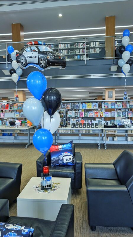 Police car balloons and themed table accents throughout the Kitchener Public Library Reading Lounge.