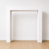 White Modern Square Arch Backdrop displayed against a white wall with light wood flooring.