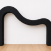 Modern wave arch backdrop rental shown in black with a smooth curved design.