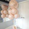 Personalized blush and gold bubble balloon bouquet with gold accents and coordinating blush-filled balloons.