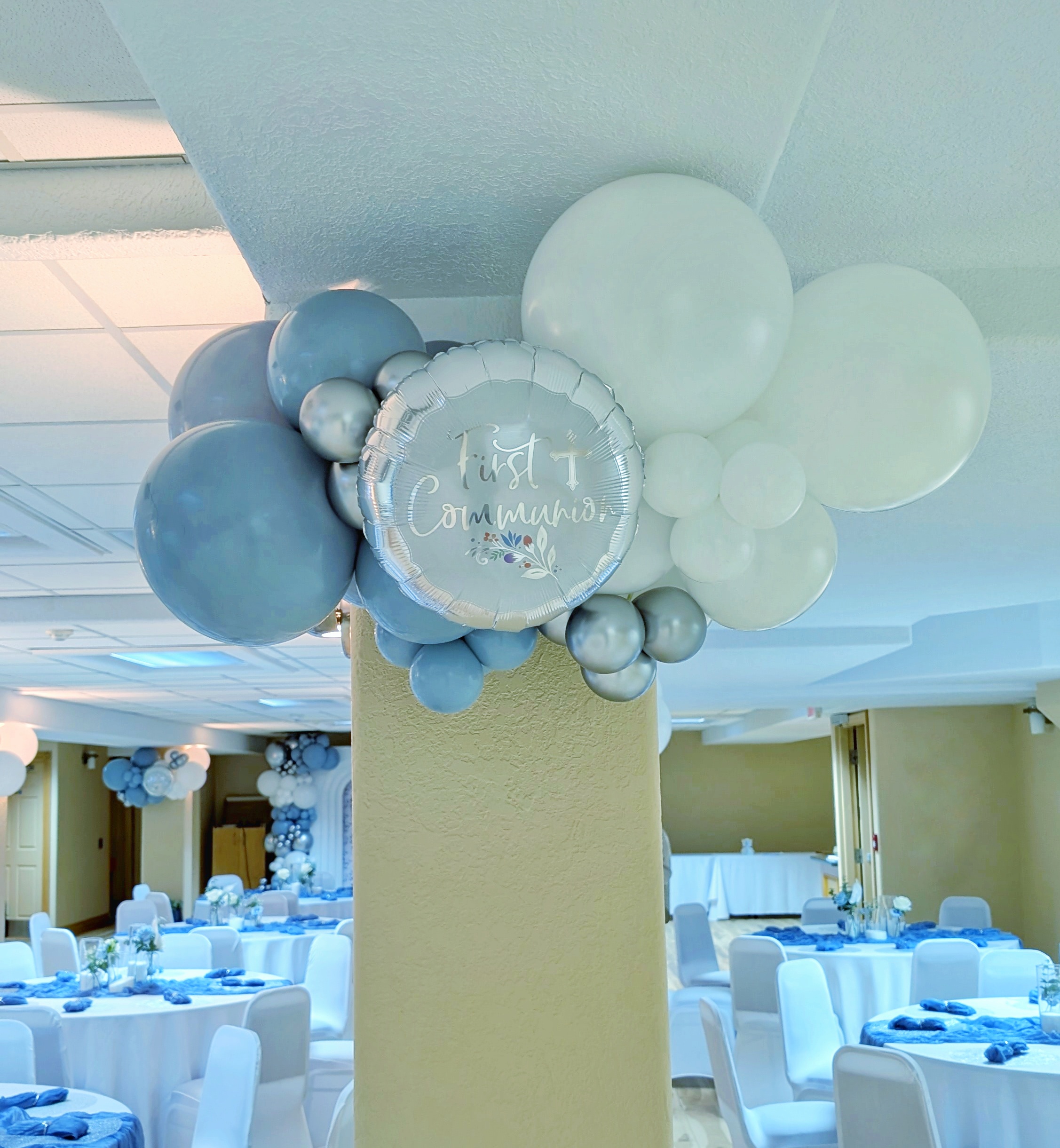 Blue, white and silver First Communion balloon garland with a decorative Communion foil balloon accent.