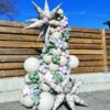Garden balloon column with neutral, sage, blush and lavender balloons, floral starbursts and greenery.