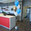 Blue, white, and reflective gold helium balloon bouquet with a coordinating balloon base.