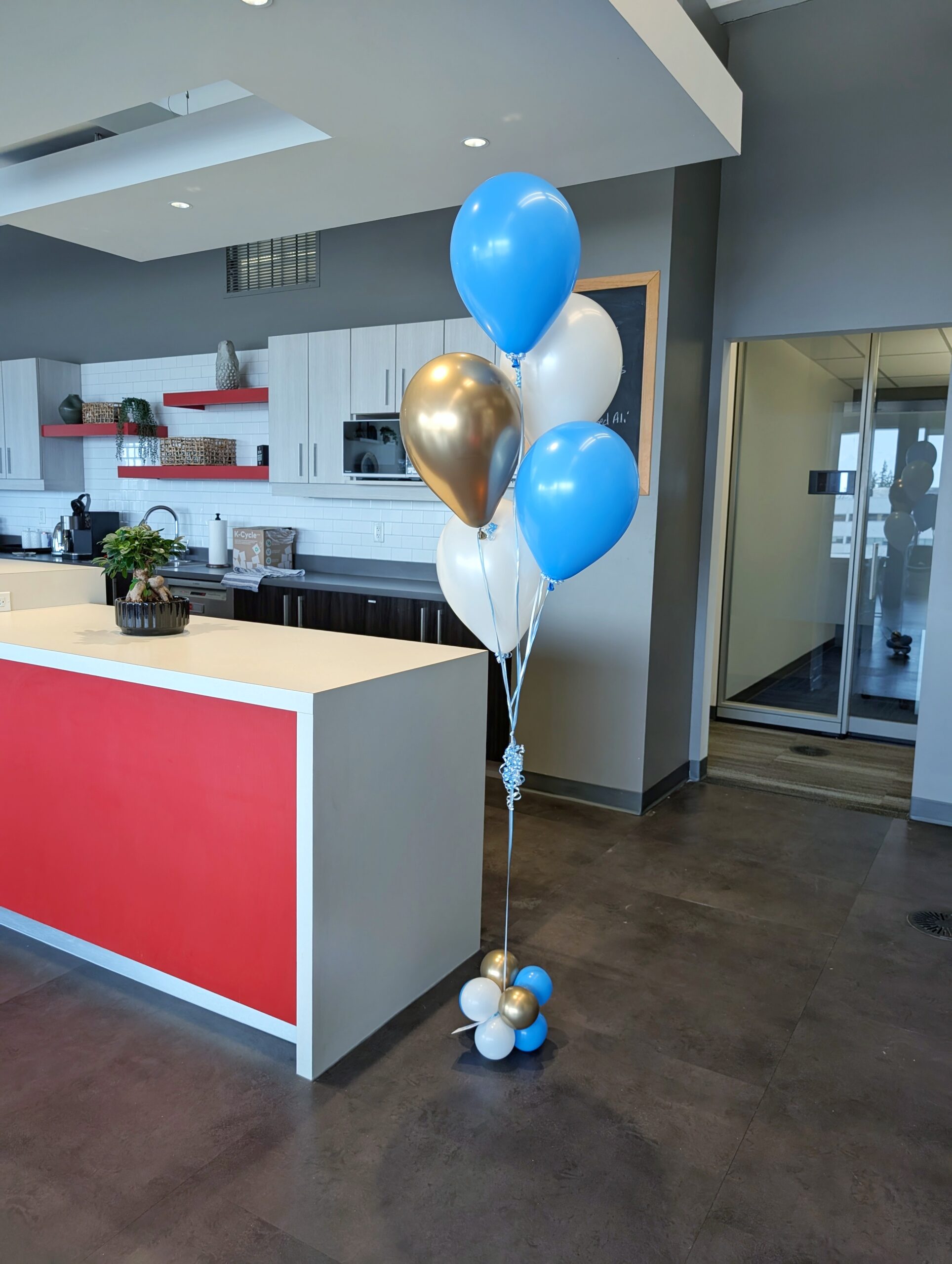 Blue, white, and reflective gold helium balloon bouquet with a coordinating balloon base.