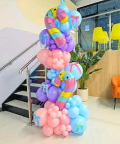 Pastel balloon column with pink, purple and blue balloons, striped candy canes and colourful bow accents.