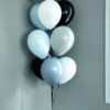 Checkered birthday balloon bouquet with black, white, and soft blue latex balloons.