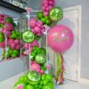 Pink and green margarita balloon garland with lime accents and a personalized jumbo helium balloon.