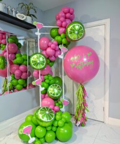 Pink and green margarita balloon garland with lime accents and a personalized jumbo helium balloon.