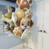 Puppy birthday balloon bouquet with paw prints, bones, and cream, gold, and brown balloons.