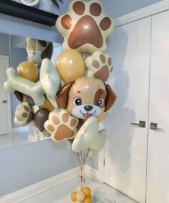 Puppy birthday balloon bouquet with paw prints, bones, and cream, gold, and brown balloons.