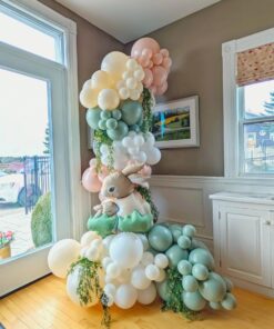Pastel bunny balloon column with blush, sage, ivory and white balloons, foil rabbits and cascading greenery.