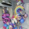 Unicorn birthday balloon combo with personalized number stack, rainbow balloons and colourful unicorn helium bouquet.
