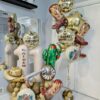 Wild West birthday balloon combo with personalized number stack, cowboy balloons, boots, cactus and gold helium balloons.
