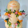 Peach farewell balloon display with orange balloons, greenery, faux peaches and a You’ll Be Missed decal.