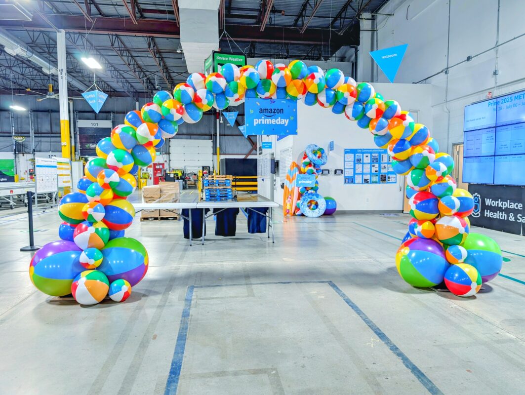 Full beach-ball arch in an Amazon warehouse for a Prime Day staff event in Kitchener.